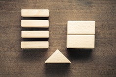 Customer Value Measurement - wood blocks above a fulcrum