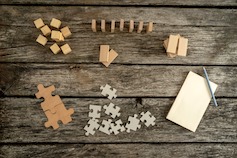Cross-Functional Priorities Workshop - various wood shapes and puzzle pieces in piles